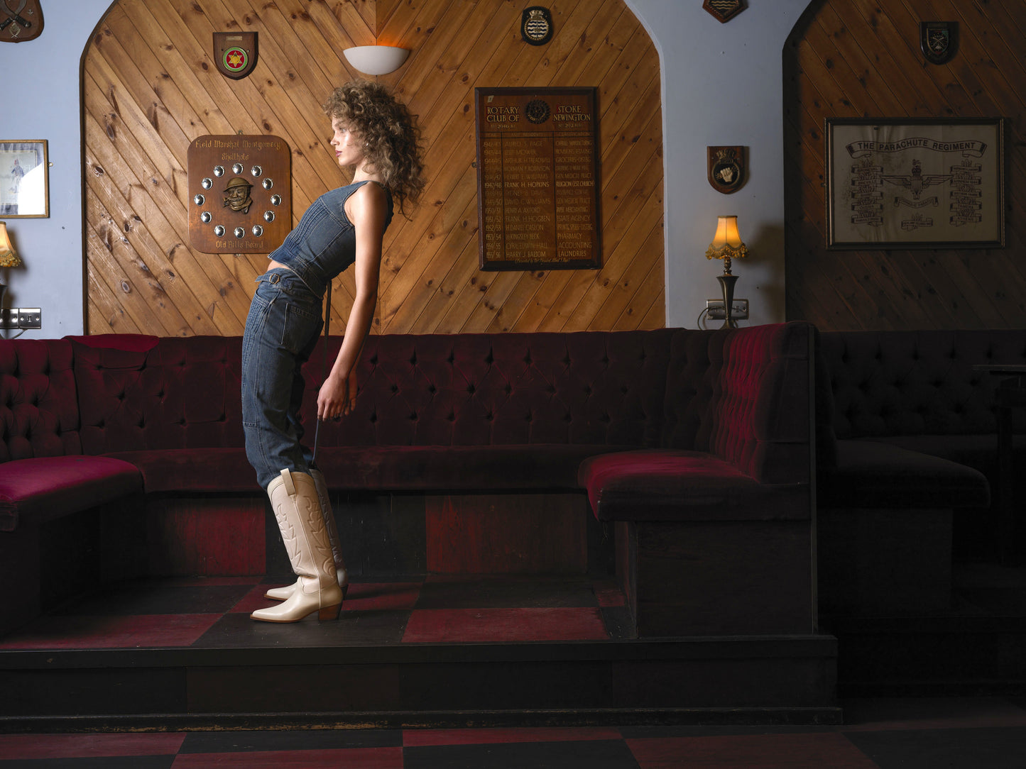 A model in the Moth Club wearing a denim outfit with white leather cowboy boot with embroidered details and a low heel - side view.