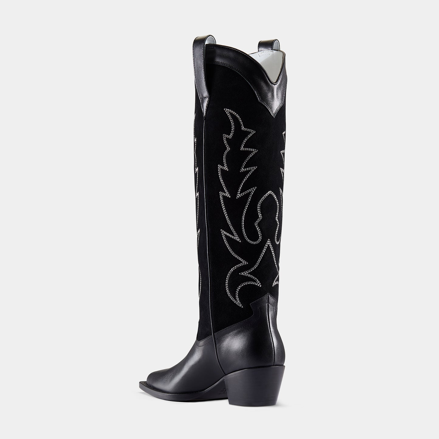 A black embroidered cowboy boot with a pointed toe, embroidered panels, and a low heel - back angle.