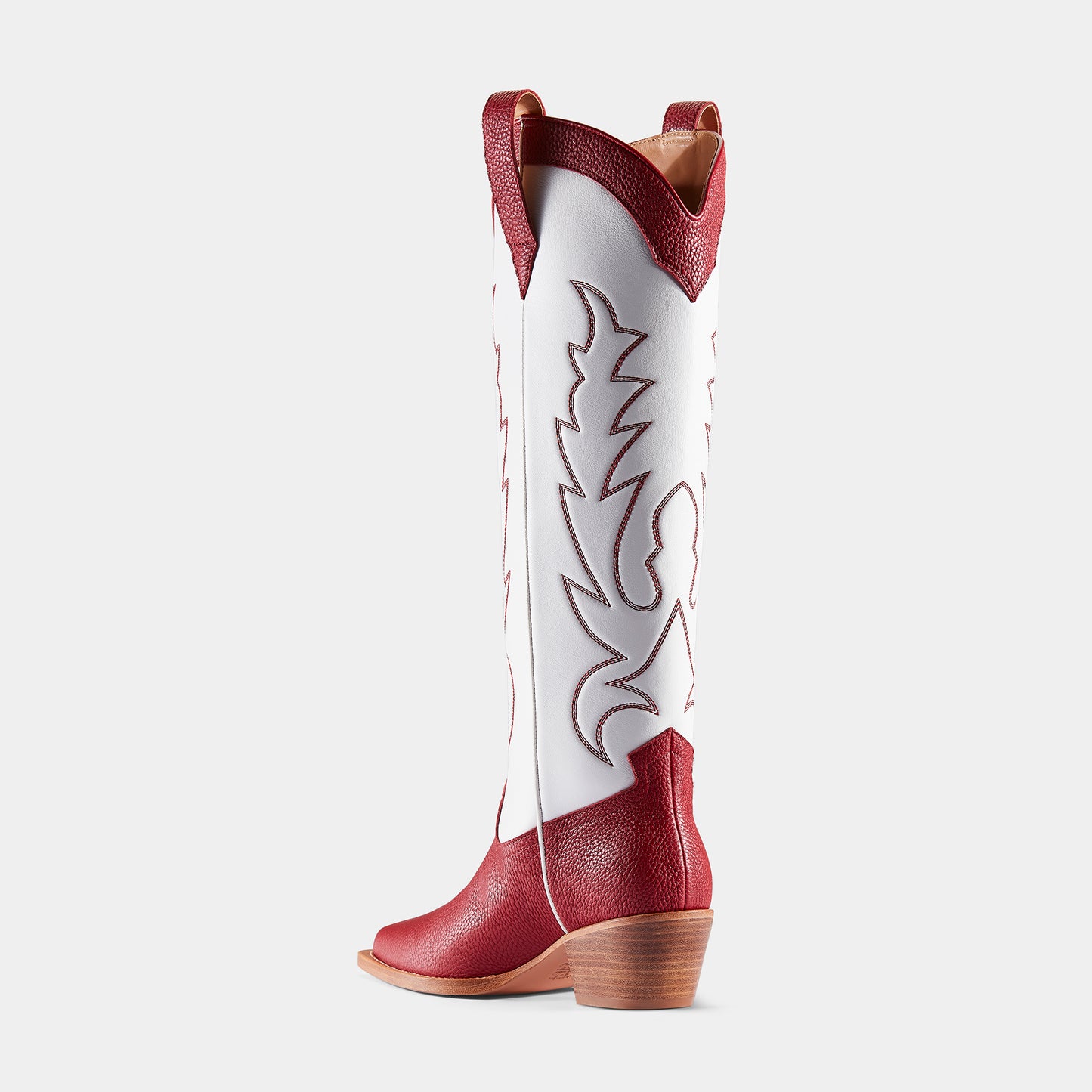 A red and white embroidered cowboy boot with a pointed toe and side pull tabs - back angle.