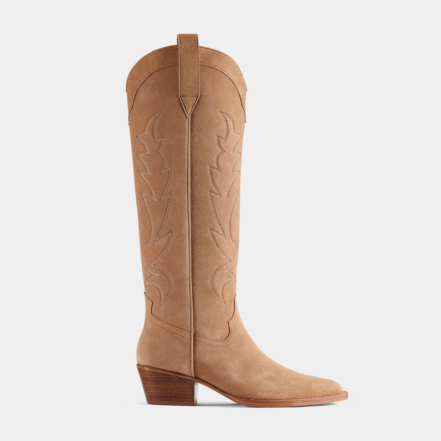 A tan-coloured suede cowboy boot with embroidered panels, a pointed toe, and a low heel - side view.