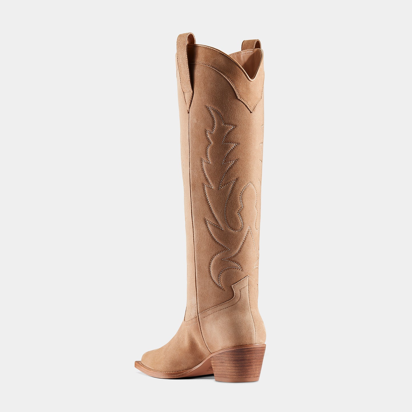 A tan-coloured suede cowboy boot with embroidered panels, a pointed toe, and a low heel - back view.