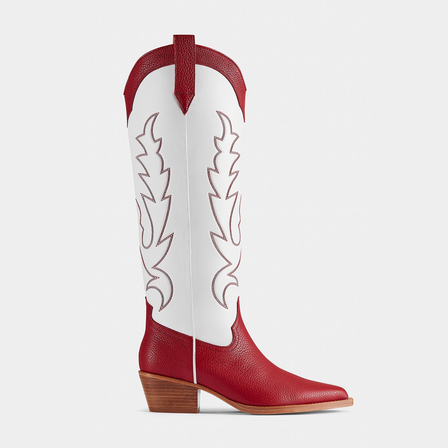 A red and white embroidered cowboy boot with a pointed toe and side pull tabs - side angle.