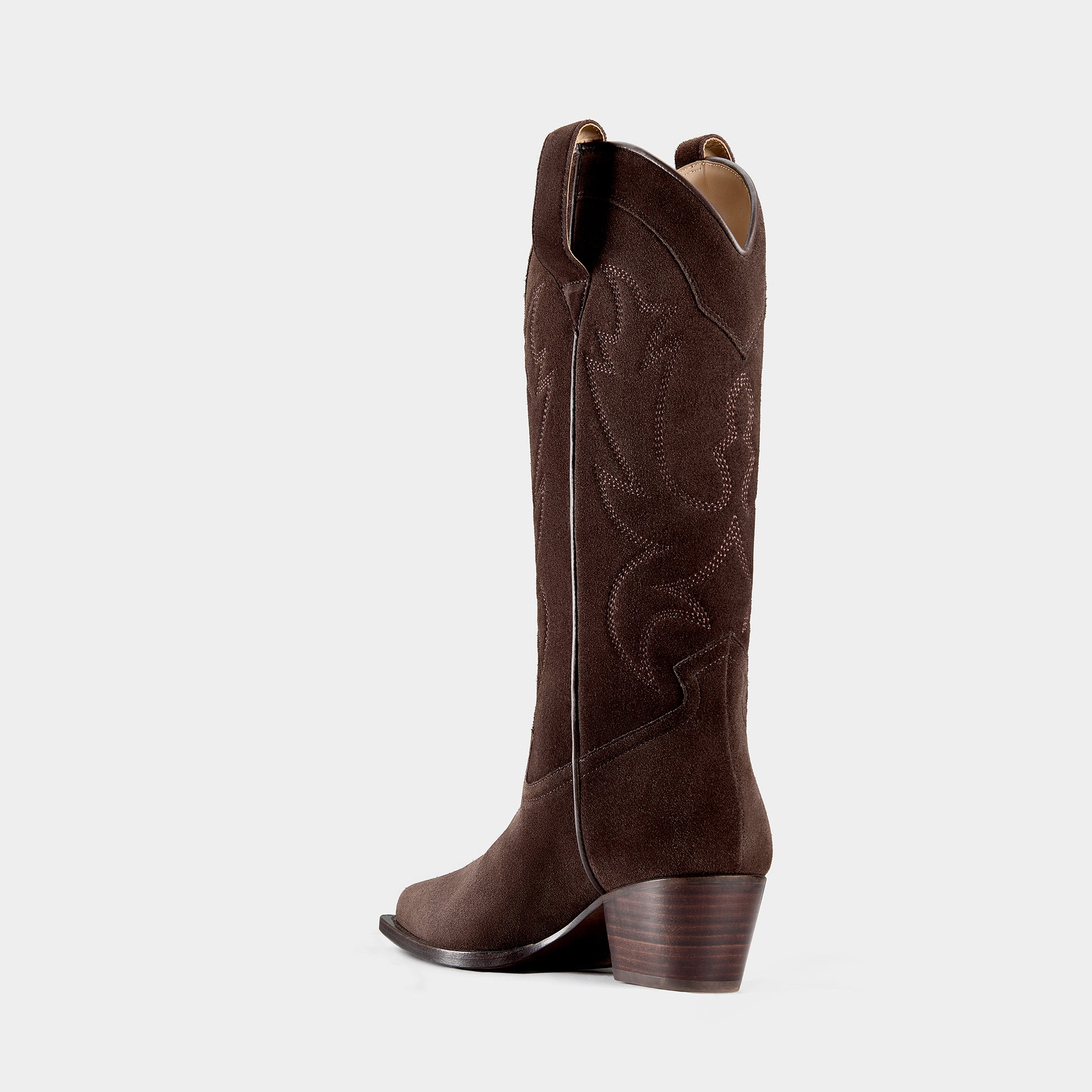 Chocolate brown cowboy boot with logo hardware on a light grey background.