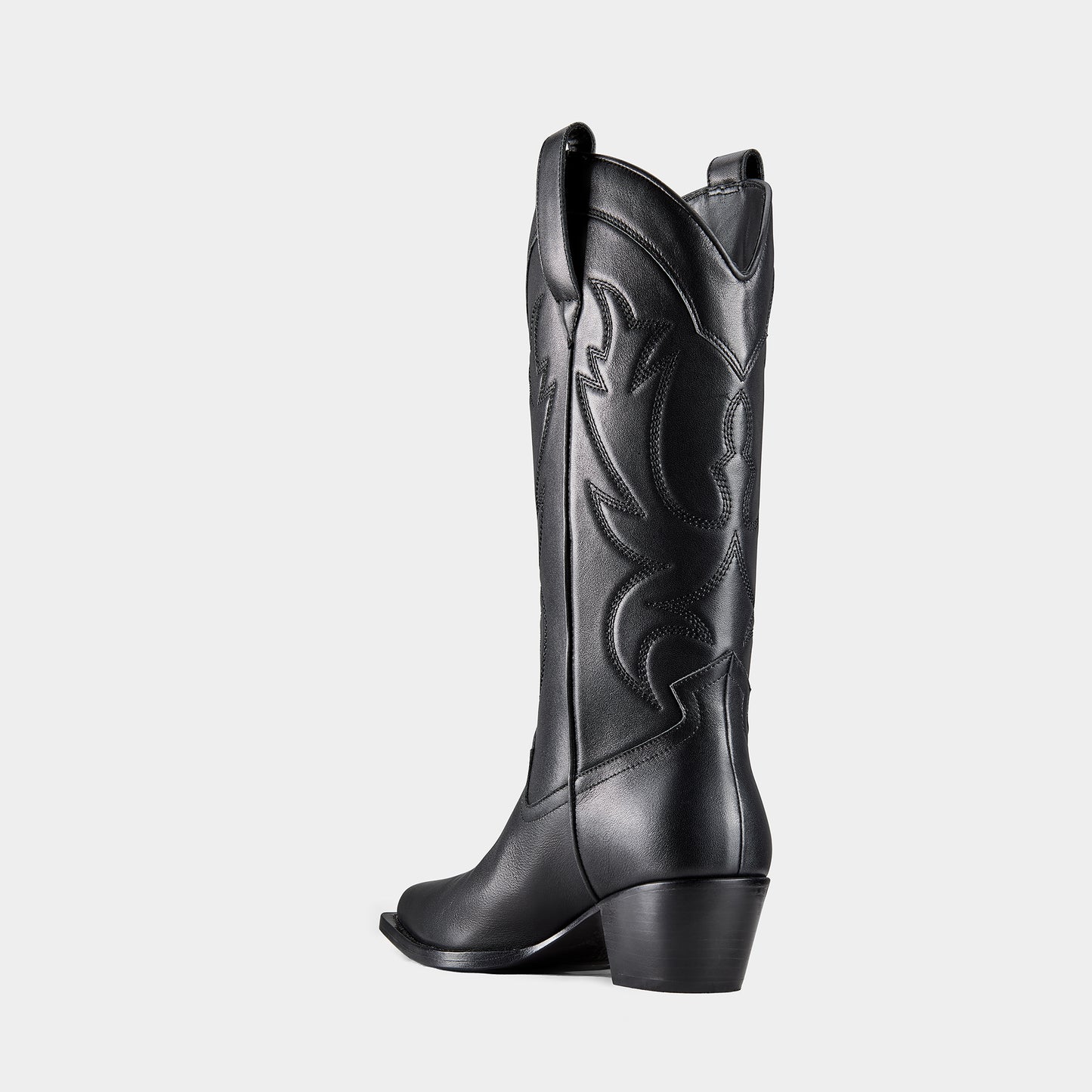 Black cowboy boot with embroidered design and metal branding on a light grey background - back view.