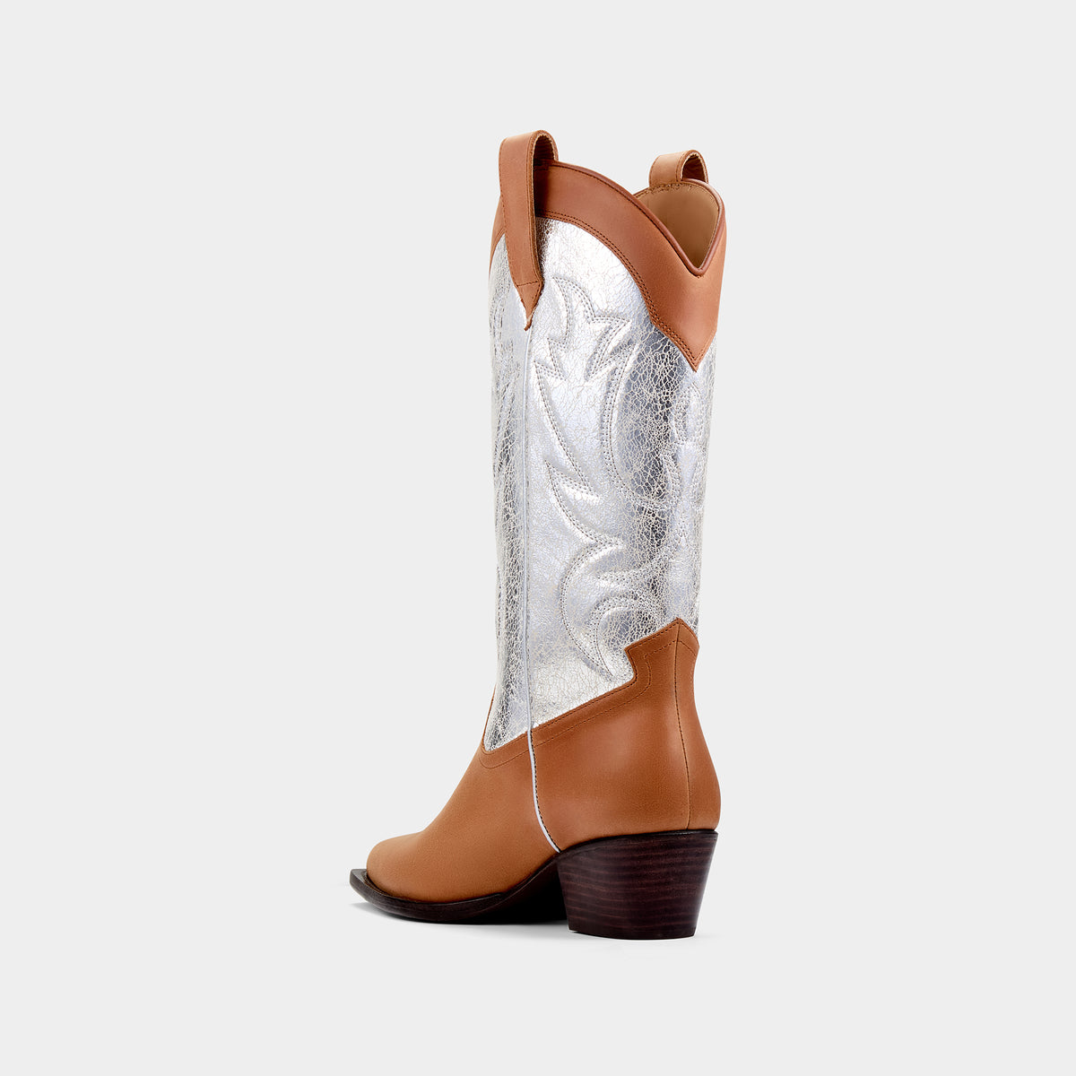 Tan and silver cowboy boot with cracked silver embroidered panels on a light grey background - back angle