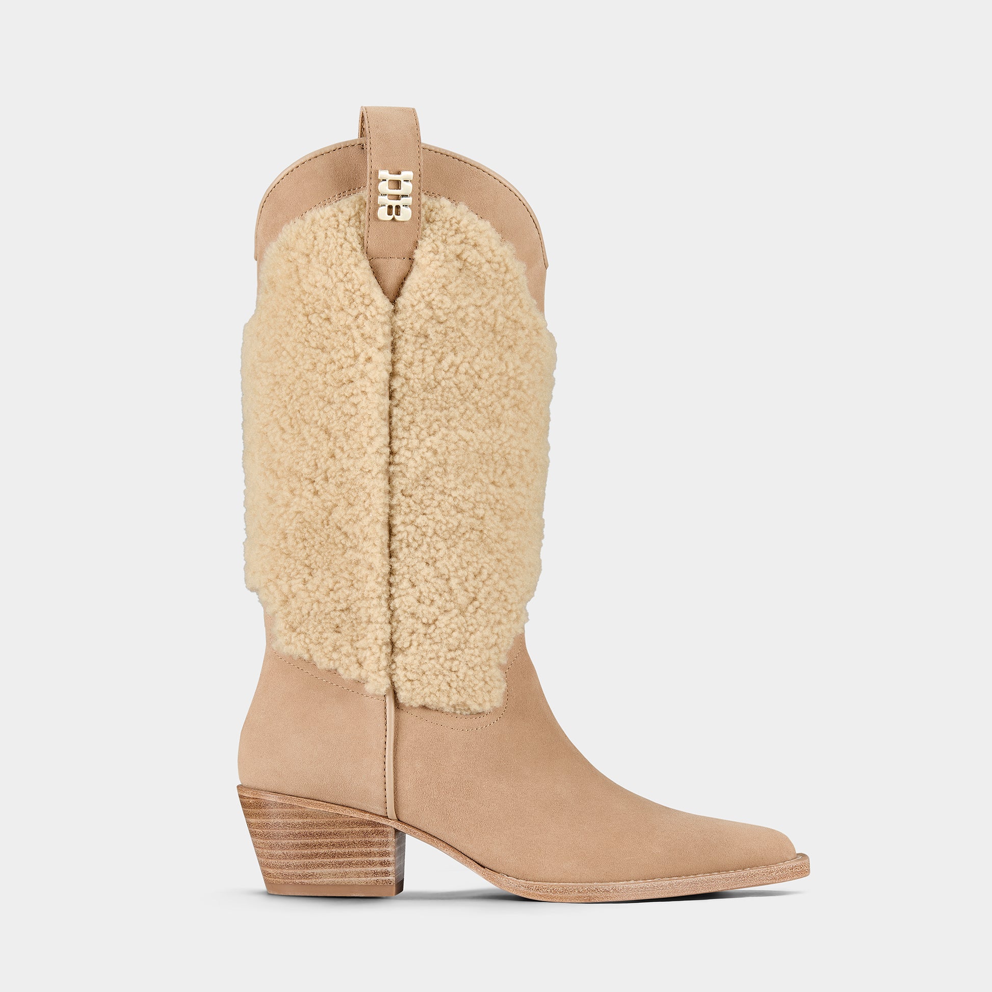 Tan suede cowboy boot with shearling shaft on a light grey background.