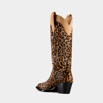 Leopard print cowboy boot with beige top on a light gray background - side angle.