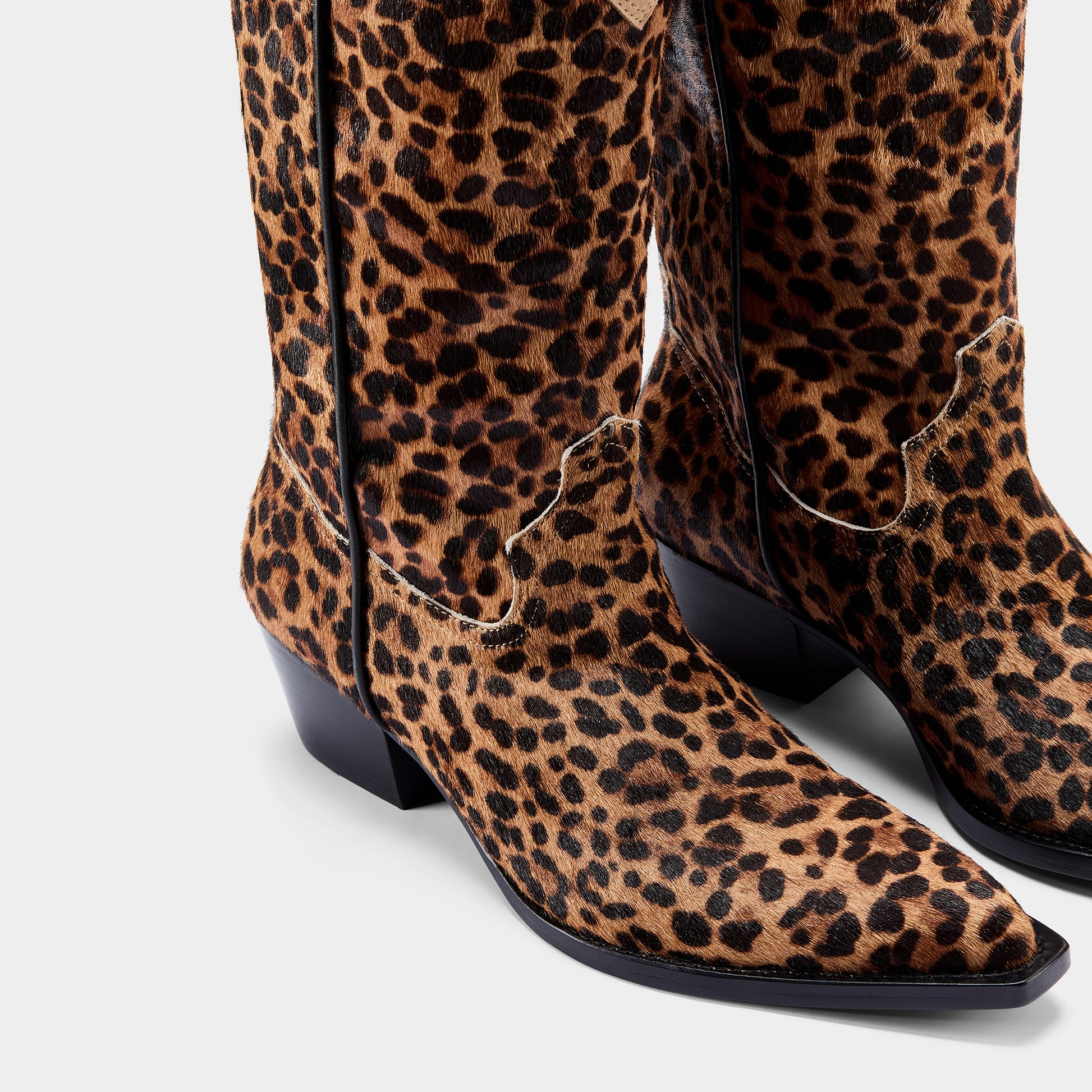 Leopard print boots on a light gray background - close up.