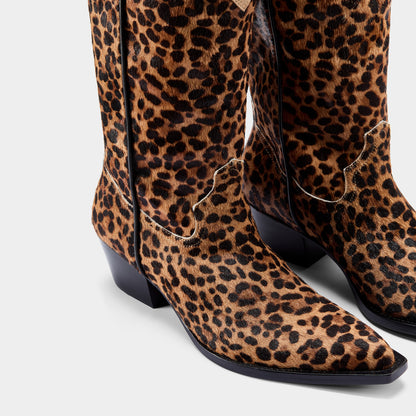Leopard print boots on a light gray background - close up.