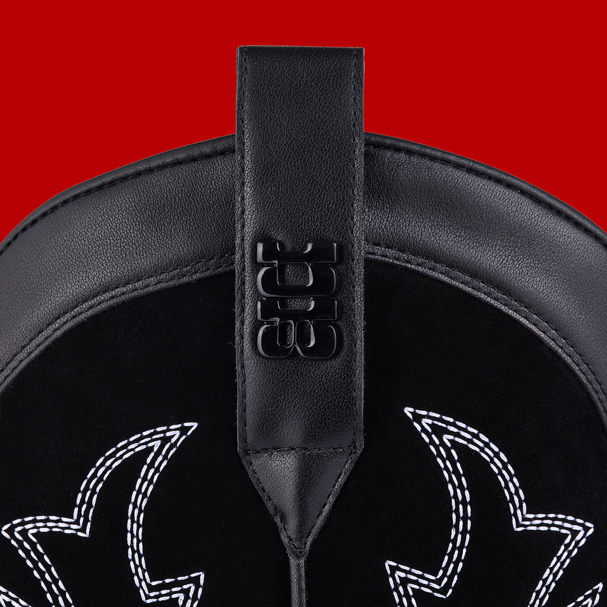 Hardware and puller detail of Mid black and bone cowboy boots