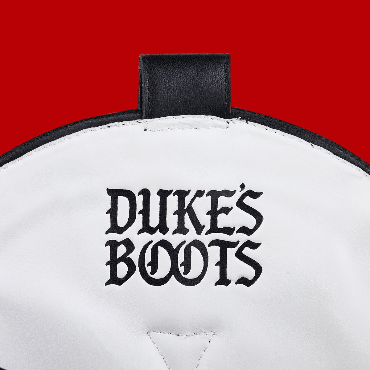 Internal view of black cowboy boot with white leather lining and black logo