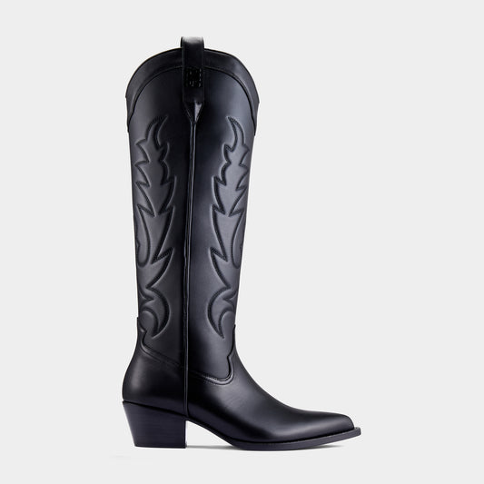 Black knee-high cowboy boot with a black embroidery design on a light grey background - back angle