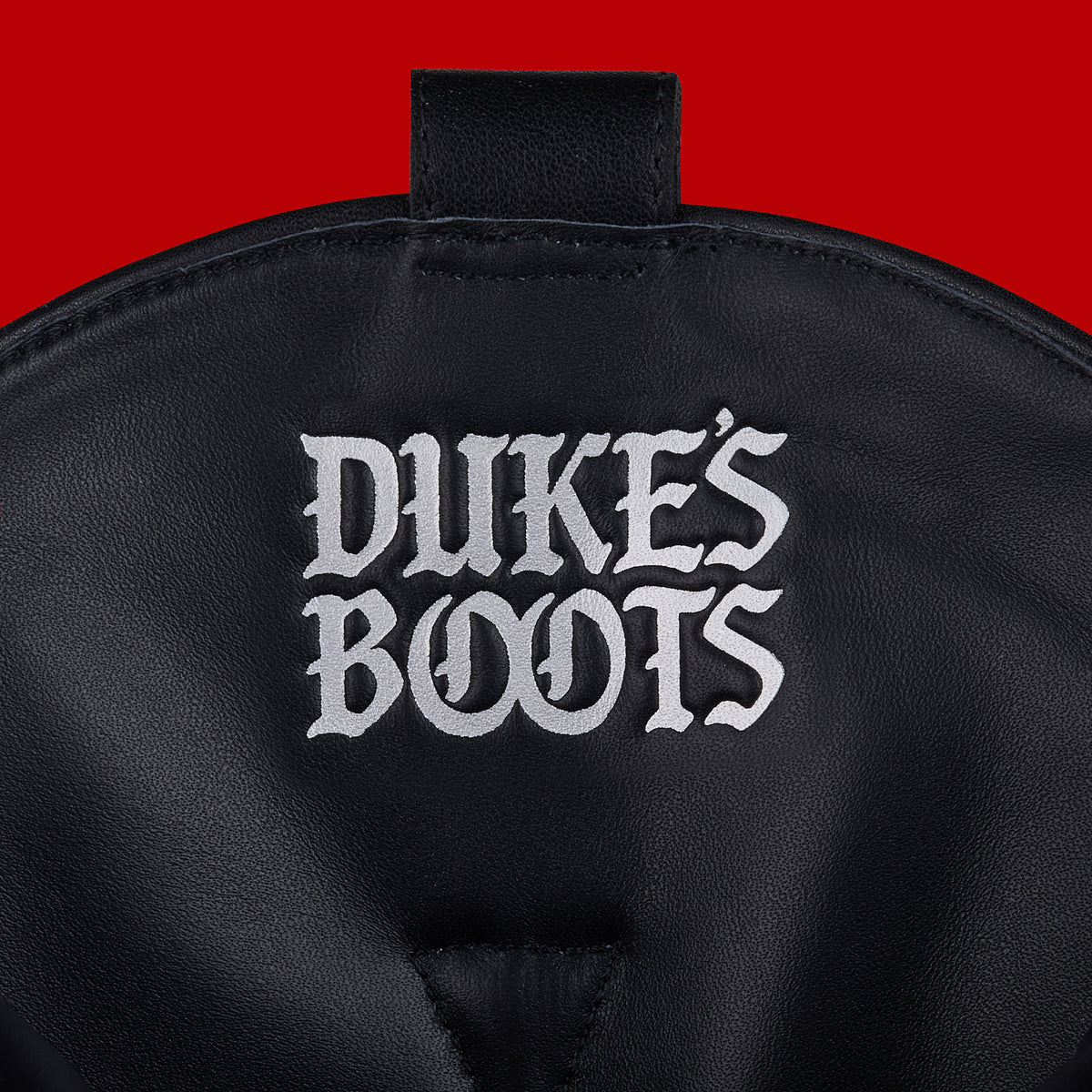Internal view of black leather cowboy boot with logo debossed in silver