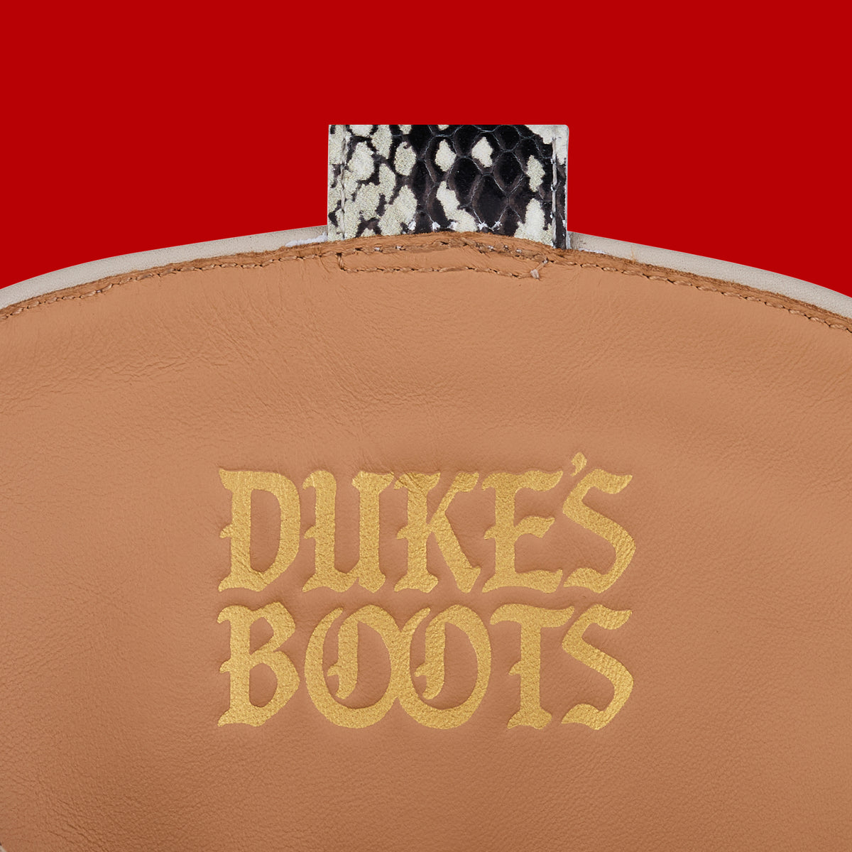Internal view of snake print cowboy boots with tan leather lining and gold debossed logo