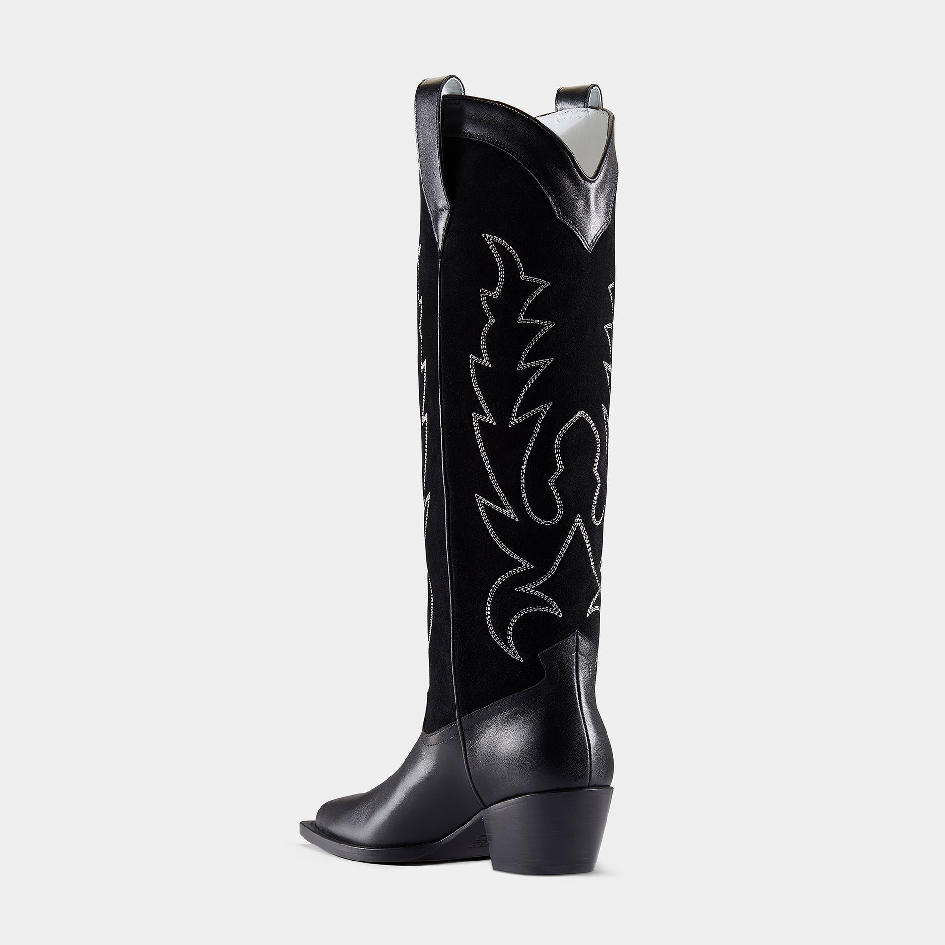 A black embroidered cowboy boot with a pointed toe, embroidered panels, and a low heel - back angle.