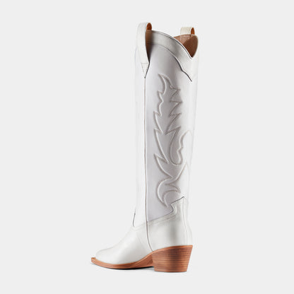 A white leather cowboy boot with embroidered details and a low heel - back view.