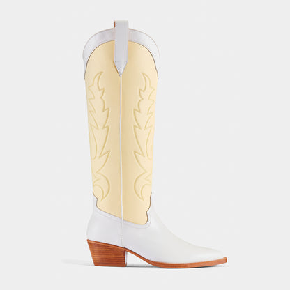 A pair of white and yellow embroidered cowboy boots with a pointed toe and low heel - side angle.