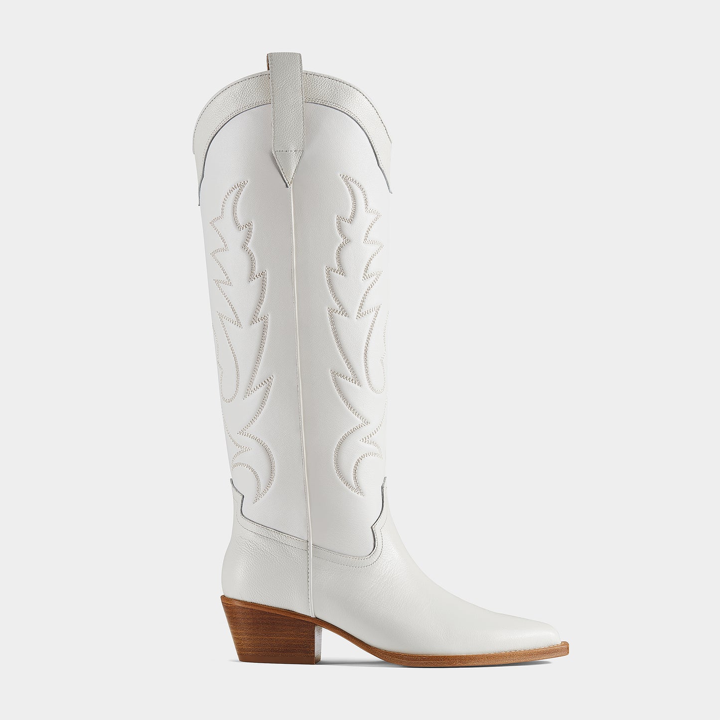A white leather cowboy boot with embroidered details and a low heel - side view.