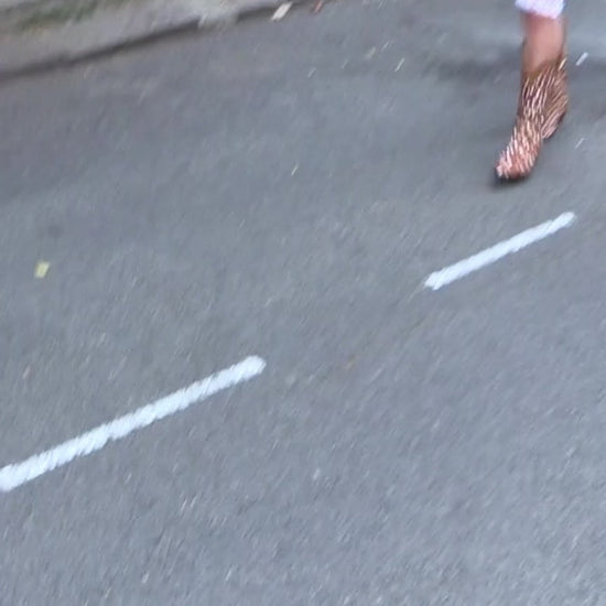Video of the Duke's Original Mid in Wild Fawn calf hair cowboy boot, model wearing lacy leggings and a leather corset on the streets of Notting Hill